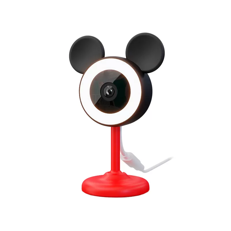 CAMARA NEXXT SOLUTIONS HOME MONITOR DE BEBE MICKEY (NHC-B100 MK) Webcam with a circular ring light and black mouse-ear accents on a red stand.