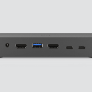 Front view of a dark gray mini PC/docking hub with power jack, HDMI, blue USB 3.0 A port, HDMI, and two USB-C ports.