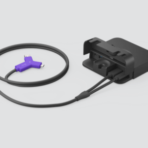 Black charging dock connected to a cable with a purple USB connector at the end, resting on a light background.