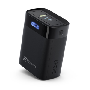 Black KlipXtreme portable power bank with blue LED digital display and top control buttons, shown at an angle to highlight its curved edges.