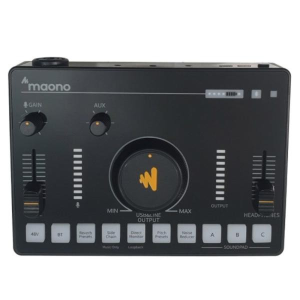 Maono audio mixer/monitoring interface with two front knobs labeled Gain and Aux, a large central dial with the Maono logo, vertical level meters on both sides, and a row of labeled buttons including 48V, BT, Reverb, and Soundpad for quick controls.