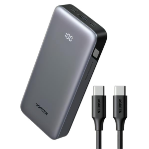 UGREEN portable power bank with a digital LED display and two USB-C charging cables beside it on a white background.